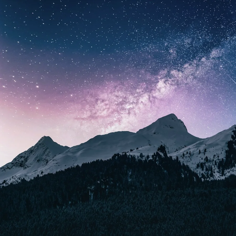 A quiet mountain landscape beneath a starry sky